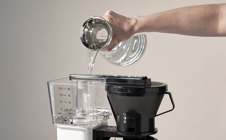 Pouring Water In Coffee Machine